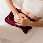 women in pain and using heat therapy