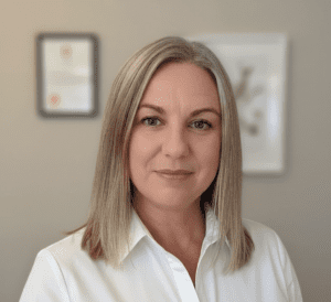 Head-and-shoulders portrait of a smiling woman with shoulder-length blond hair wearing a white blouse. Amber Pickering, practitioner at Westmead Clinic